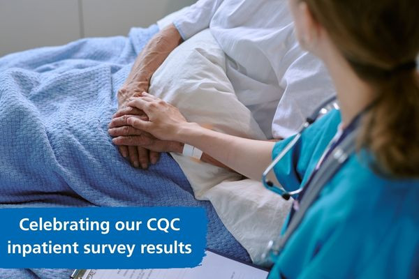 Patient in hospital bed with doctor holding their hand. Text says celebrating our CQC inpatient survey results