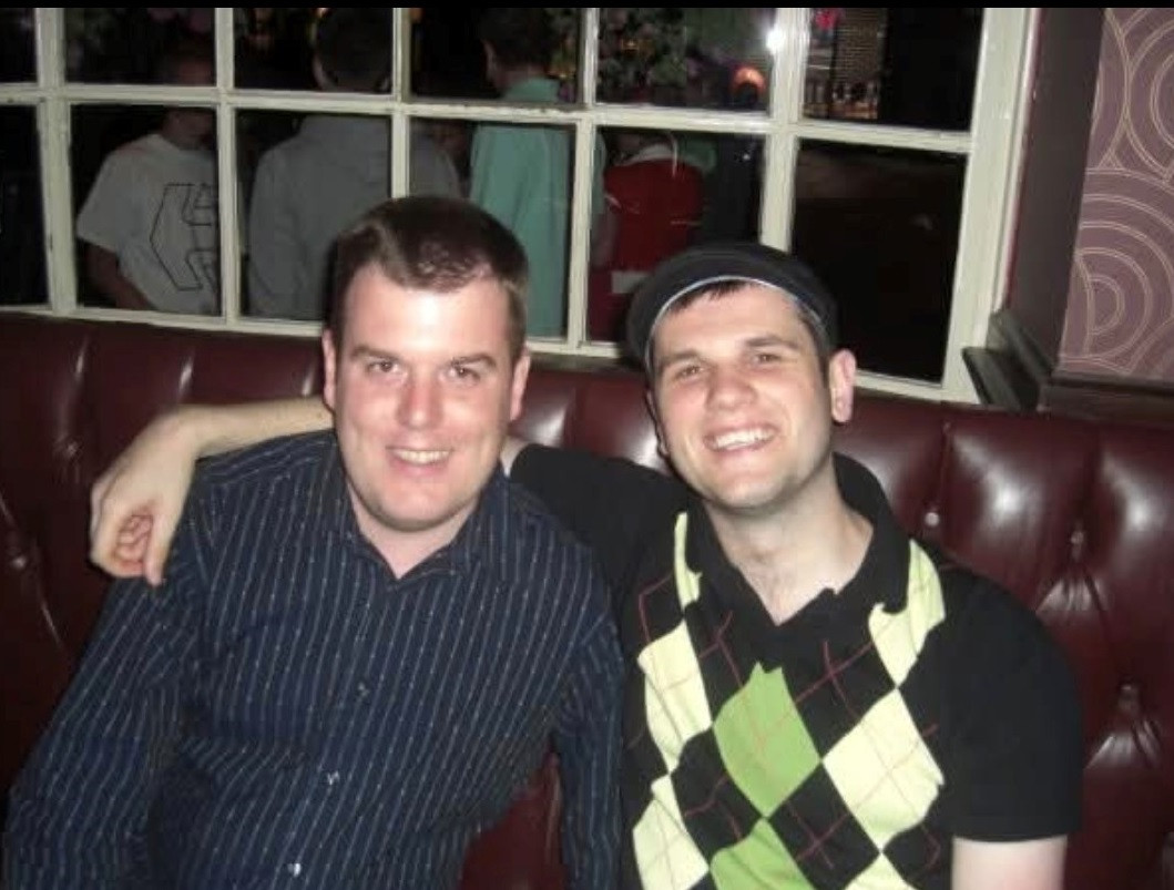 Jamie with his brother Tom, sitting on a sofa