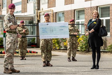 Gurkhas handing over a cheque to East Kent Hospitals Charity