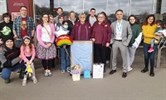 Avatar of Linda Moore and the ED team. Image shows Linda and her daughter Tracy outside Sainsbury's with the ED team. There are about 30 people in the photo. Linda is holding a framed scrubs top and there are some flowers and gift bags next to it.