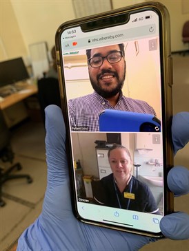 Audiology staff using technology to talk to a patient