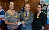 Avatar of rotary presentation. Image shows Carrie Merry, Chris Hedges and Joanna Watungwa. They are pictured inside holding a cheque