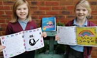Avatar of Isla and Maisie with the book they helped illustrate. They are pictured wearing school uniform holding the book PS Thank You Very Much
