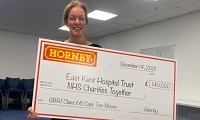Avatar of Jess Evans with the cheque from Hornby Hobbies. Photo shows Jess holding a giant cheque made out to EKHUFT and NHS Charities Together for £140,000