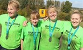 Avatar of Jessie, second from left, with her family after the challenge. Image shows four women in green t-shirts - they are muddy and smiling at the camera.