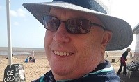 Avatar of Michelle Keen's dad David Hayman, who died from Coronavirus. He is sitting by a beach wearing sunglasses and a hat