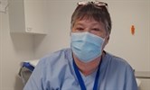 Avatar of Roz Mallory who is retiring after 45 years. She is pictured in a clinic room, sitting at a desk, wearnig a uniform and face mask.