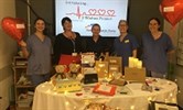 Avatar of the team at the Kent and Canterbury Hospital at the launch of the 3 Wishes Project there. Image shows a group of staff standing behind a table with various items on. Behind them is a screen that says introdcing the 3 Wishes Project