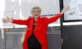 Avatar of Gloria Hunniford with Caron, the new mobile unit for East Kent. Image shows her standing in front of the unit with her arms outstretched.