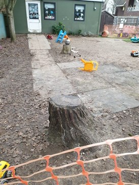 Before the transformation. Image shows a mud area with some children's toys in.