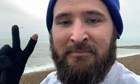 Avatar of Ben Sackett, who is doing a run for East Kent Hospitals Charity. He is bearded, wearing a hat, and holding two gloved fingers up in a v sigh.
