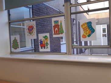 Some of the festive pictures sent by local children to Padua ward at the William Harvey Hospital. The image shows pictures displayed on a window in the ward