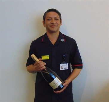 Avatar of Chris Hamson, who has recieved a Chief Nursing Officer's Silver Award. He is pictured in uniform holding a bottle of Champagne