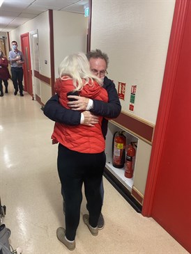 Donald Williamson is reunited with wife Jane as he leaves hospital. They are pictured embracing in a hospital corridor as staff look on