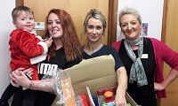Mum Amy Morgan and son Logan with donations and ED Staff
