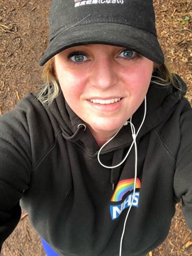 Gemma Jordan, an HCA on Seabathing ward at the QEQM, who is doing a charity challenge in March. It is a selfie photograph taken outside and she is wearing a cap and looking up at the camera.
