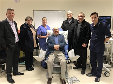 Members of PCSA Kent with the medical chair they have donated