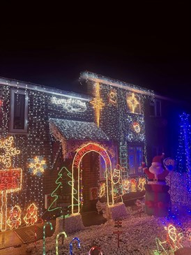 John Parker's Christmas lights display. Image shows a house and garden covered in Christmas lights of all colours and shapes