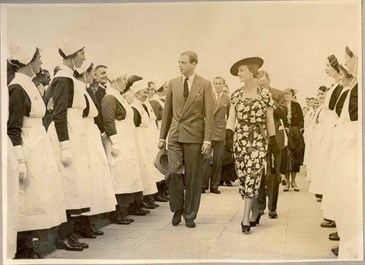 KCH 1937 opening Duke of Kent and Marina and staff. Sepia image showing nurses lined up with the Duke and Duchess of Kent walking between them.