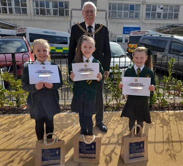 Lord Mayor of Canterbury Cllr Pat Todd with the girls. Image shows Pat standing behind the girls, who are holding certificates. They are outside the hospital