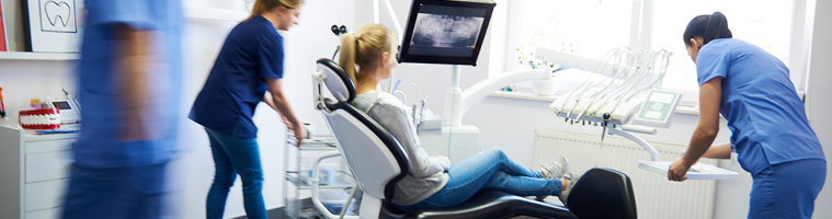Dental nurses and patient in chair