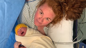 Michelle Keen with baby Isabelle, who was born by emergency c-section before her husband could make it to the hospital. She is pictured in the operating theatre just after the operation