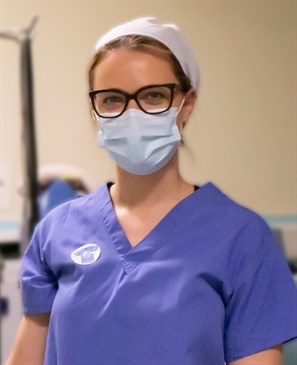 ODP Chloe Paine. Picture shows Chloe Paine, an operating department practitioner, wearing scrubs and looking at the camera in an operating theatre environment