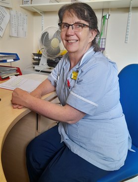 Patricia Selway. She is sitting at a desk, wearing a nurse's uniform