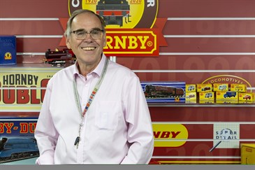 Simon Kohler from Hornby Hobbies, who have donated £140,000 to East Kent Hospitals Charity from the sales of a model engine dedicated to Captain Tom. He is pictured in front of a display of model trains.