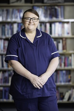 Tammy Pilton-Pluck, an international nurse from Australia. She is pictured wearing a dark blue nurses' uniform