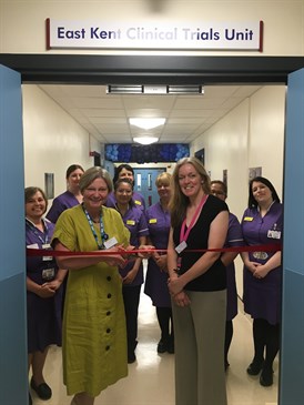  Tracey Fletcher and Jess Evans at the opening of the CTU . Image shows Tracey about to cut a ribbon across a corridor watched by Jess, with other members of the research team behind them