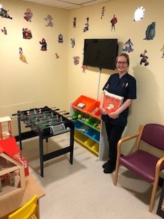 Sarah Whibley with the new books in the children's waiting room