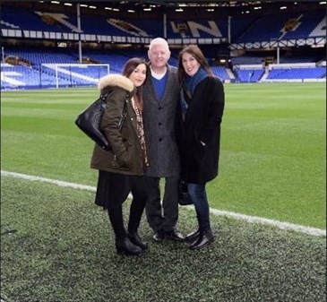 Yasemin Thompson with her husband David and daughter Yeliz. They are pictured on the pitch at Everton football stadium, with David in the middle, Yasemin on the right and Yelik on the left.
