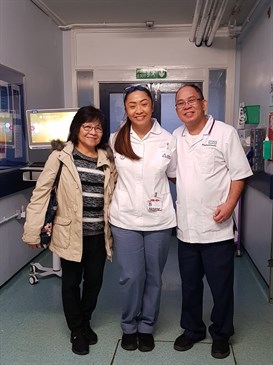 Zoe Montellano with her parents Josefina and Mannie before he became ill. They are pictured in a hsopital corridor, Zoe and Mannie are wearing medical uniforms