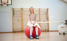 serial casting girl sitting on the red ball 