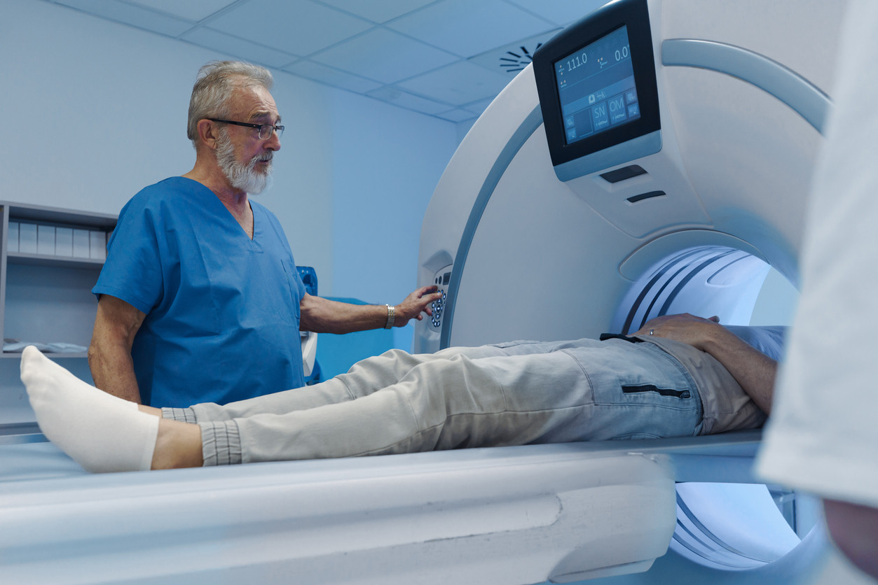 Doctor operating a CT scanner in hospital