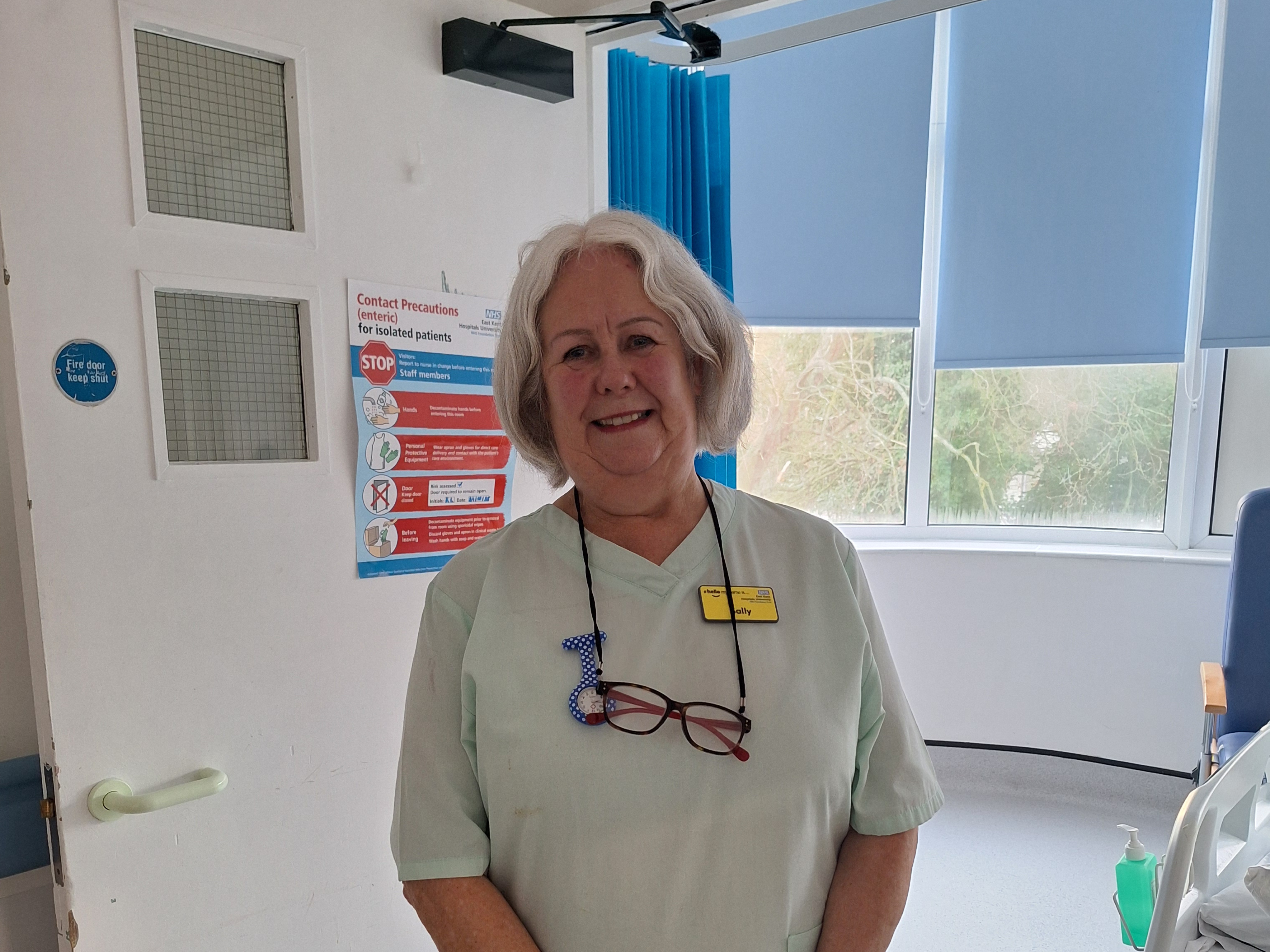 Sally wearing scrubs and on the ward