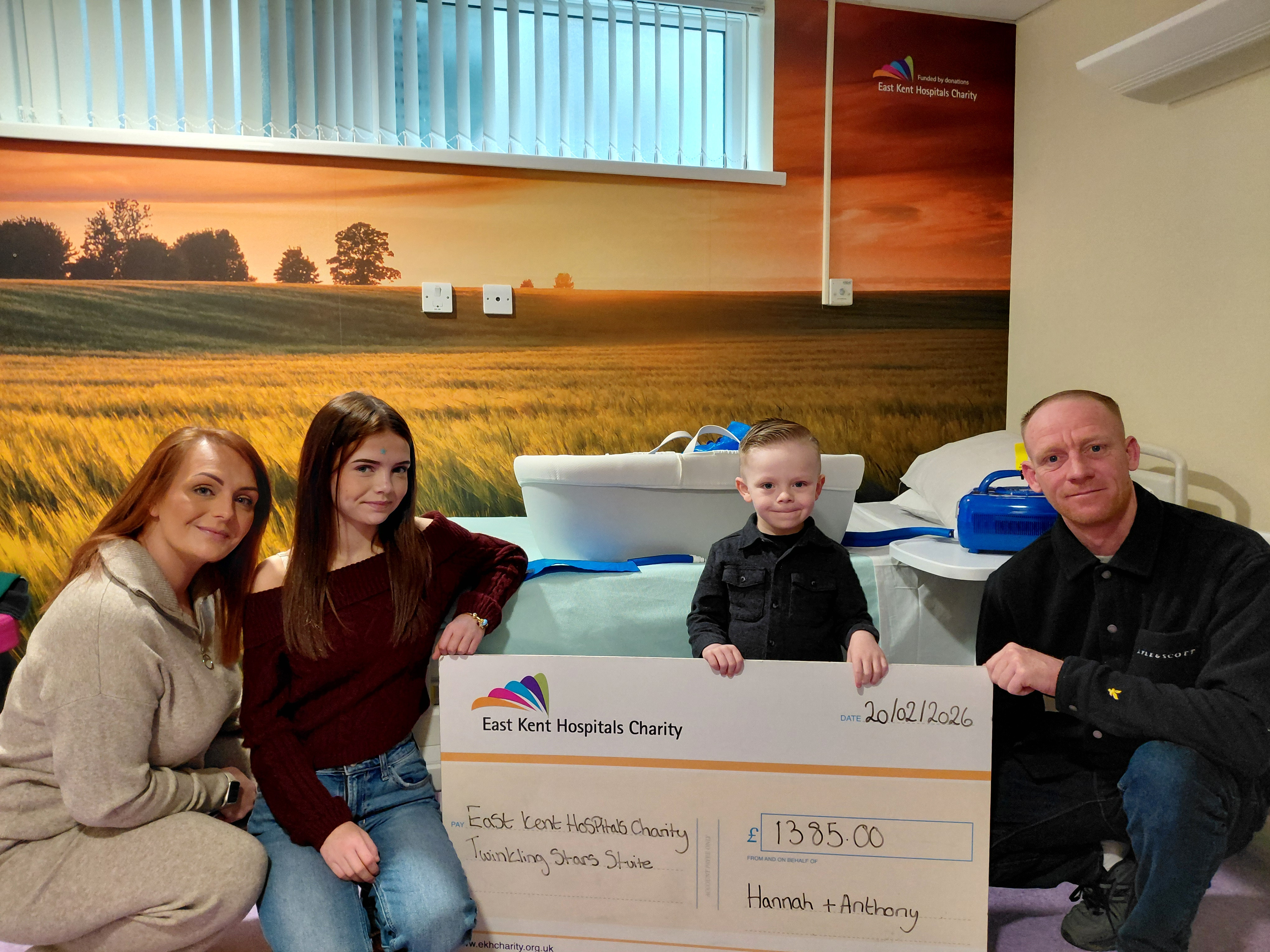 Hannah Bartholomew and Anthony Smith with their children and a giant cheque