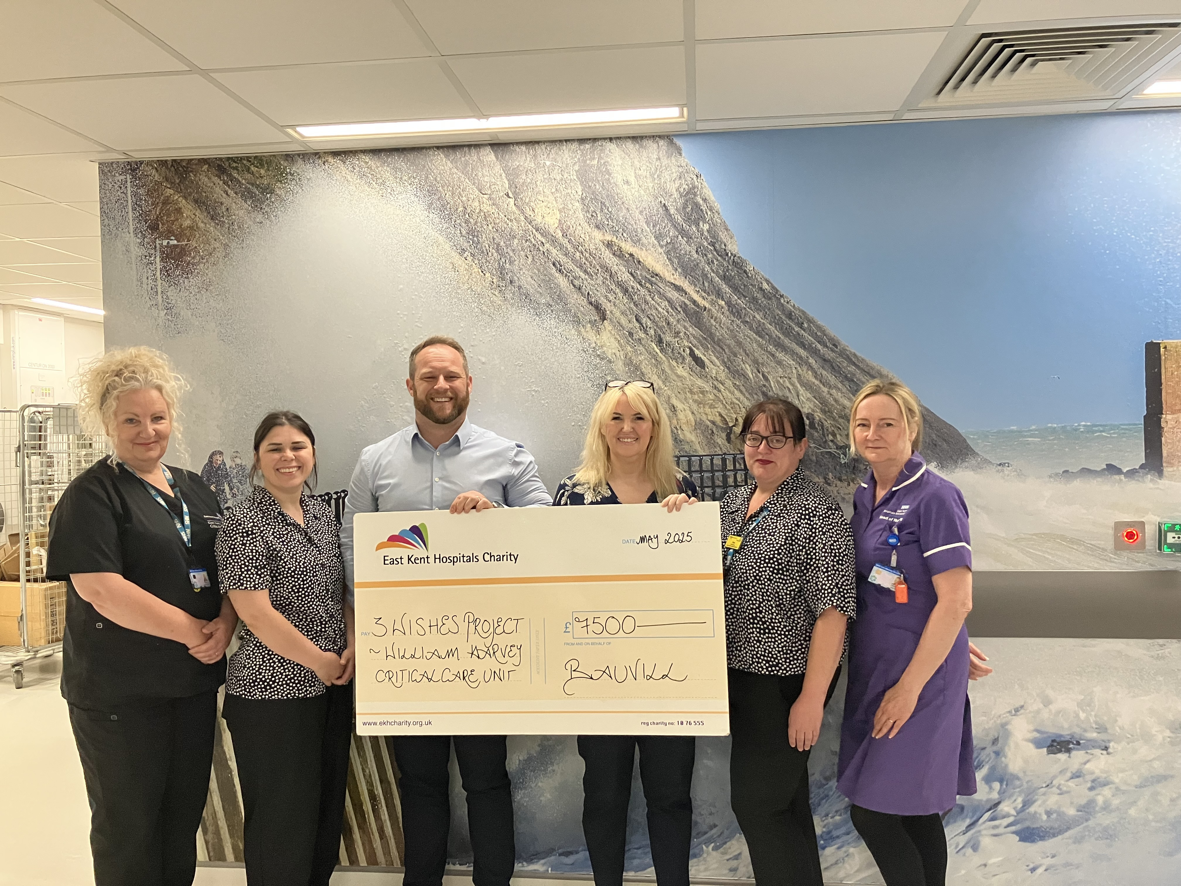 Matt Gurr from Bauvill with staff from the critical care team and a giant cheque