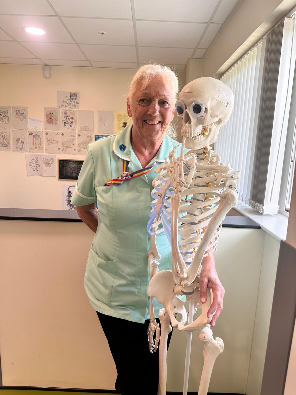 Sue Baker, who is celebrating 50 years of caring. Pictured with a skeleton