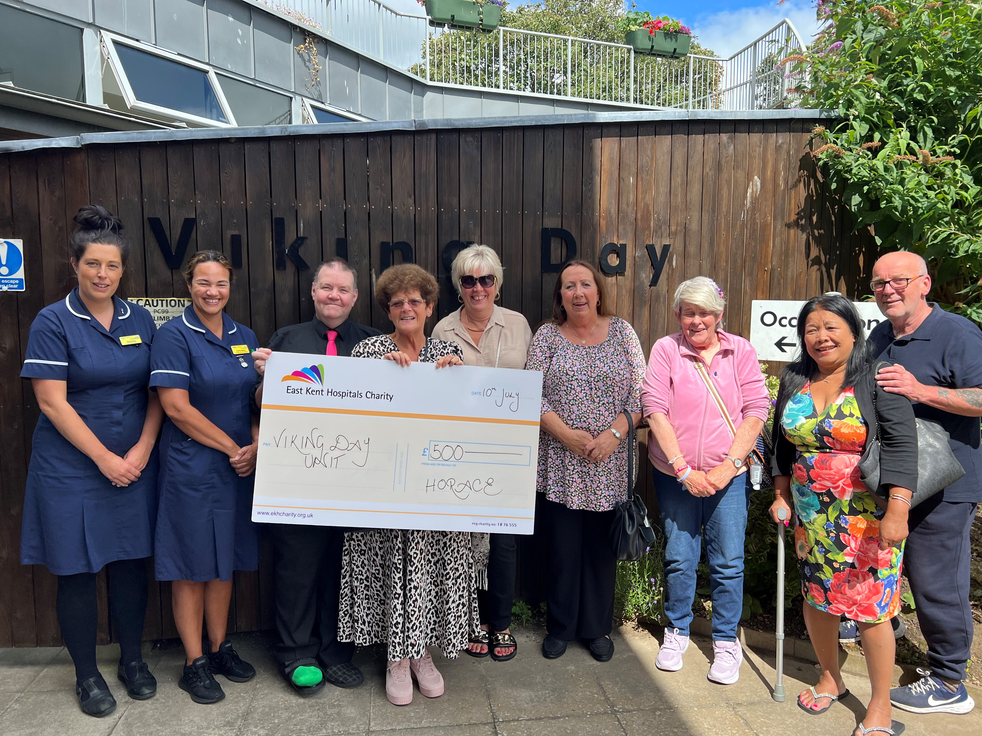 Horace and friends present the cheque to the Viking Day Unit team