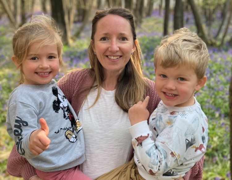 Louise Linden with her son Oscar and daughter Alice. They are pictured in woodlands with bluebells behind them