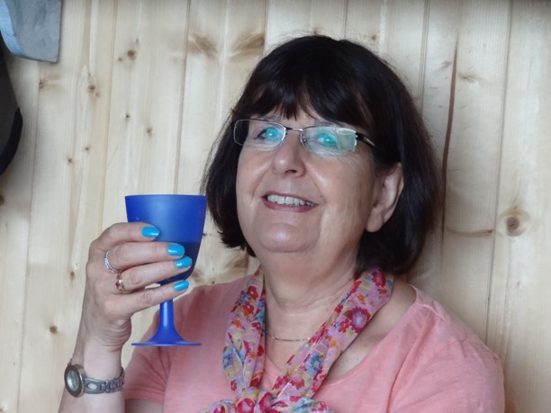 Mary Noble, holding a blue glass