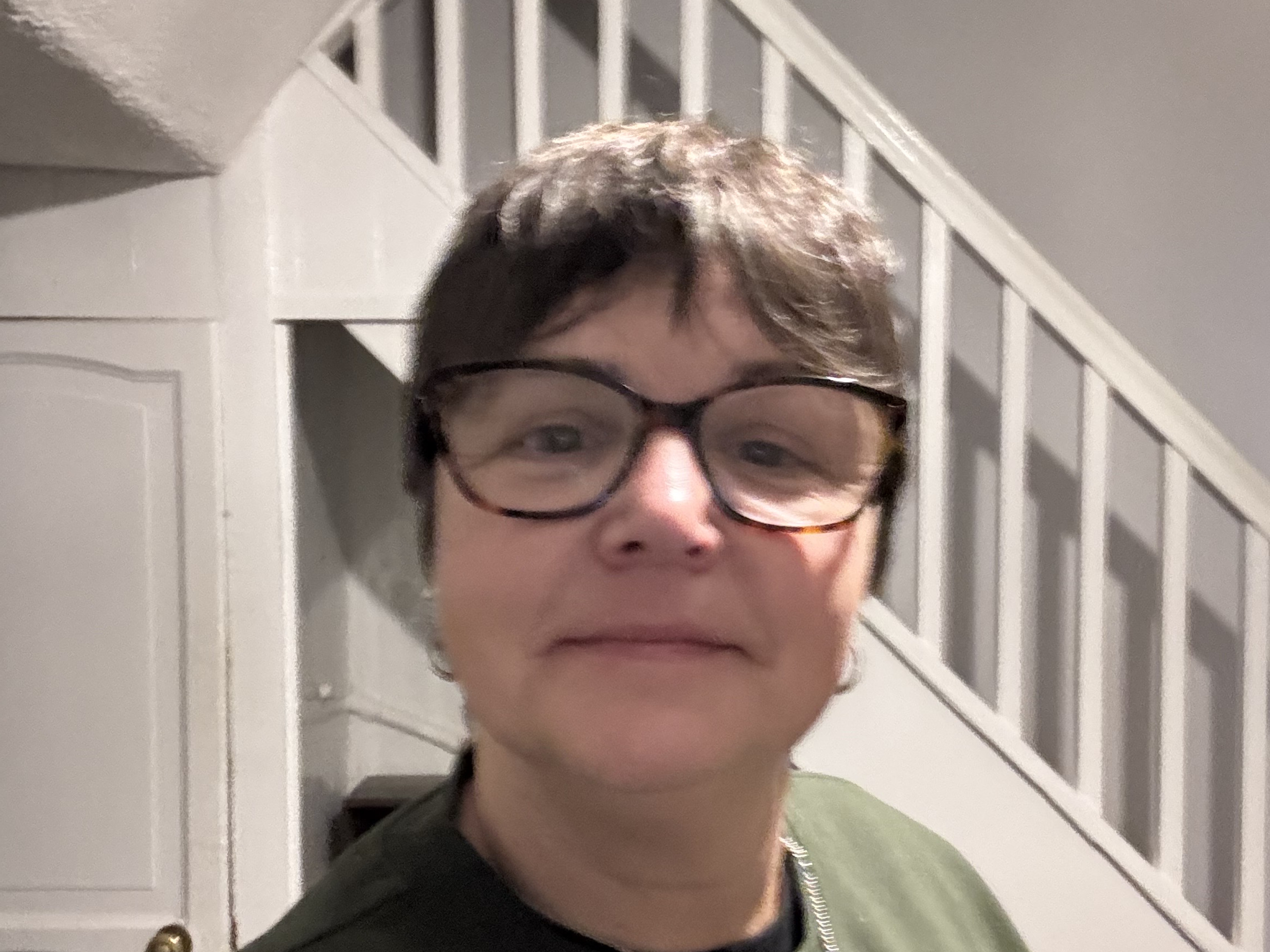 Michelle Griggs. Head and shoulder shot in a house with stairs behind