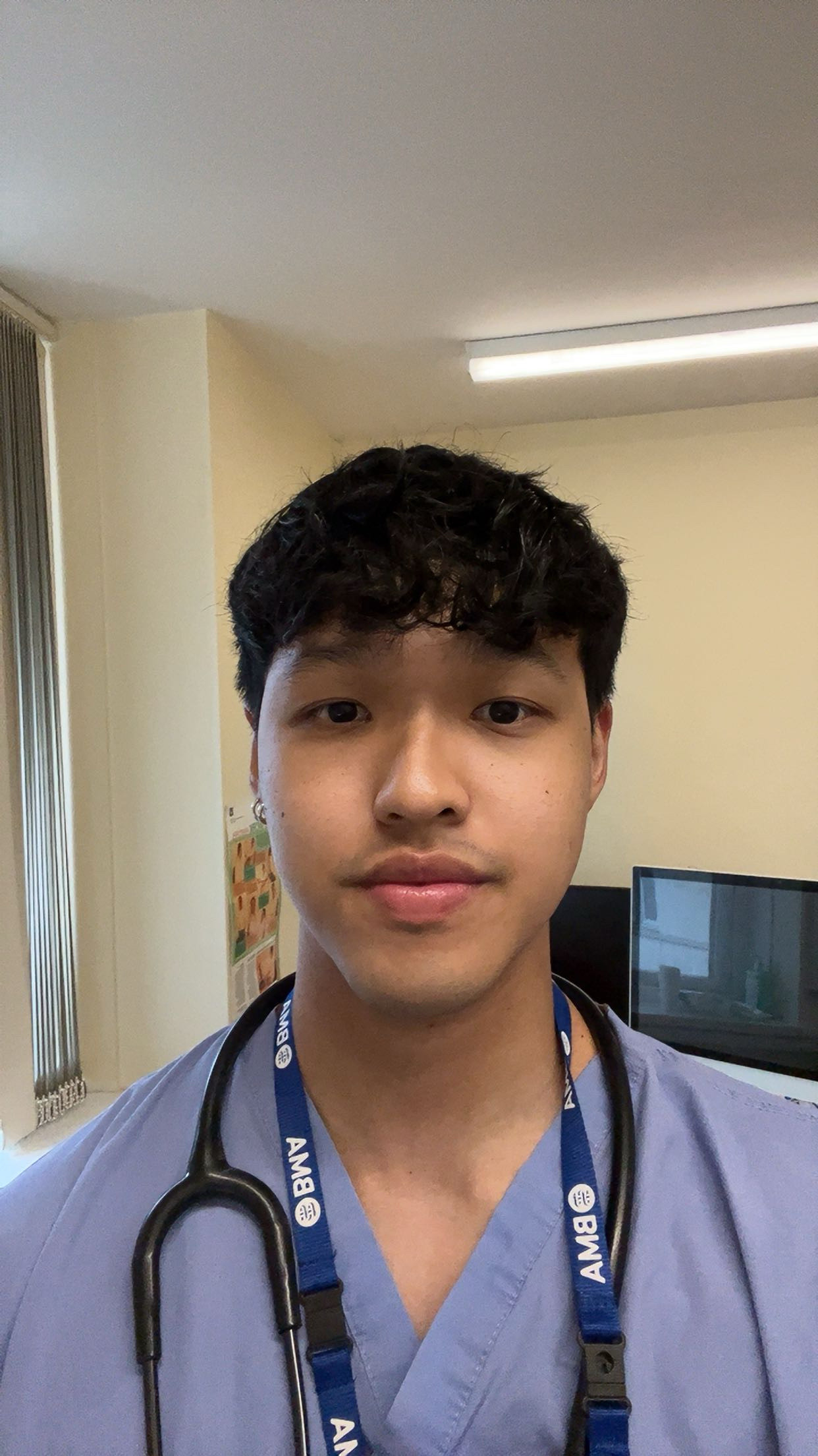 Namling Limbu, an FY1 doctor at the William Harvey Hospital who was born there. Pictured in scrubs with a stethoscope