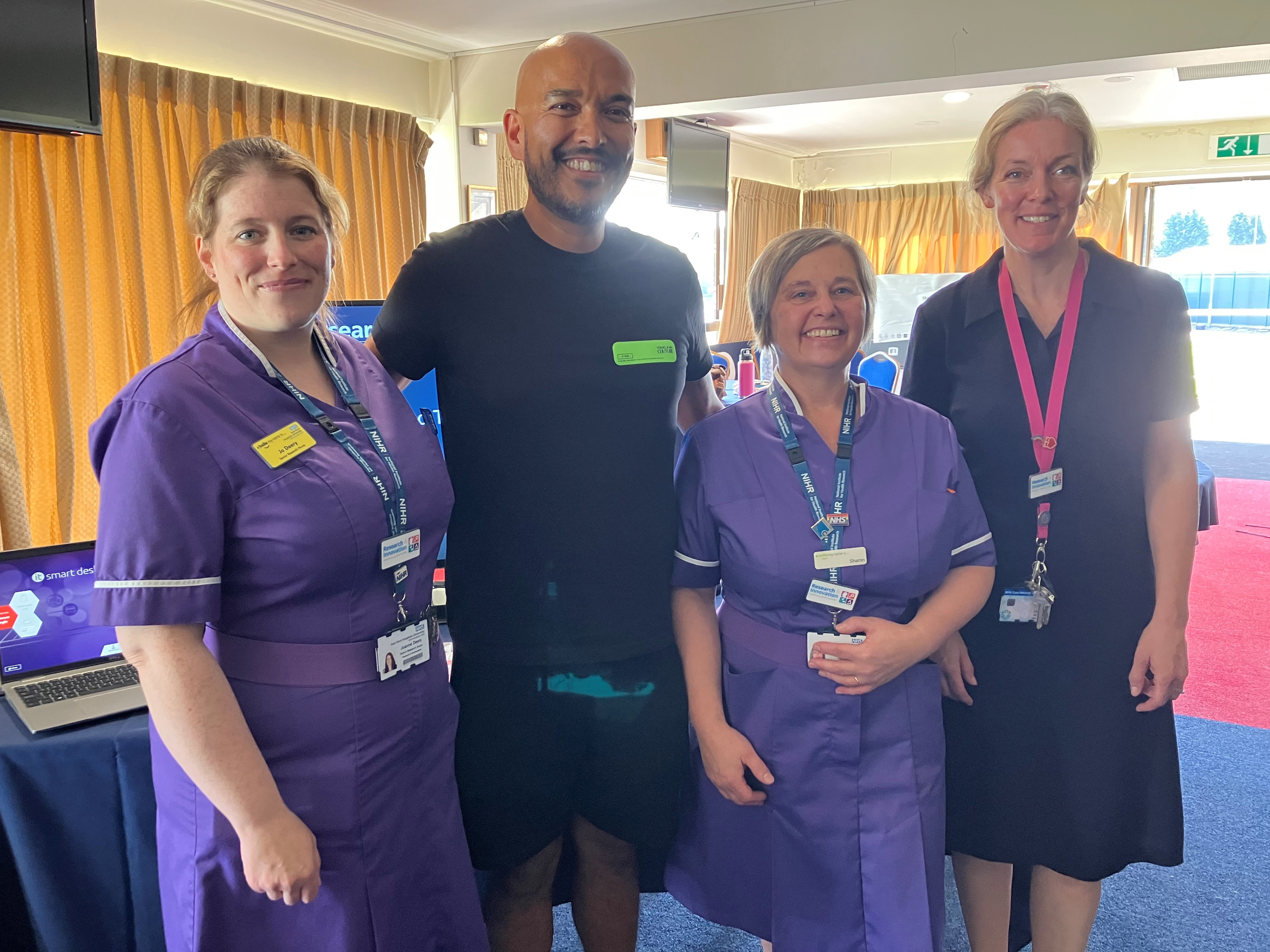 Research team members with a patient who has been involved in a surgical trial