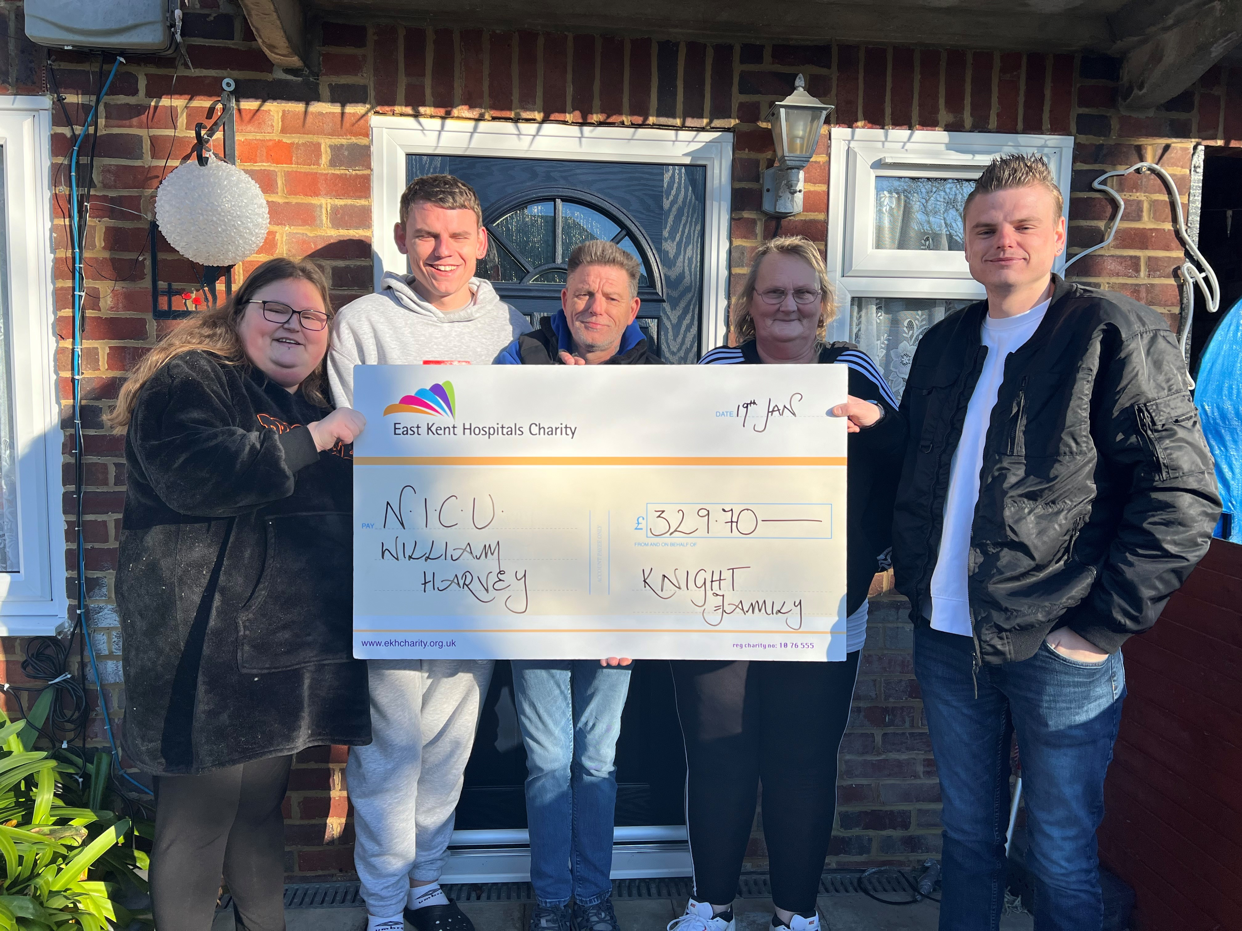 The Knight family with a giant cheque for £329.70