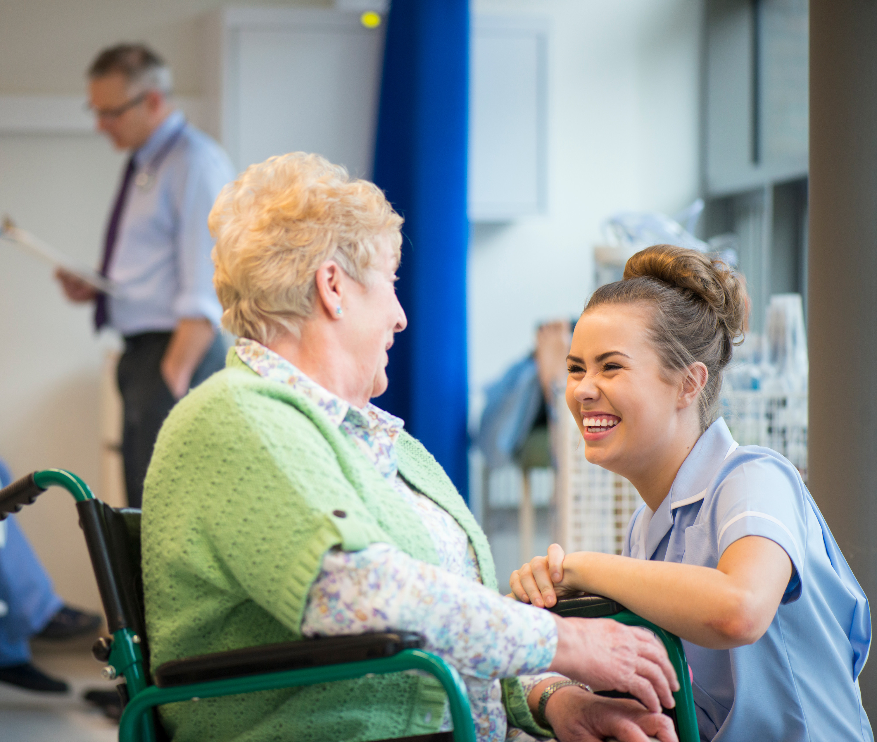 Nurse chatting and laughing with a patient