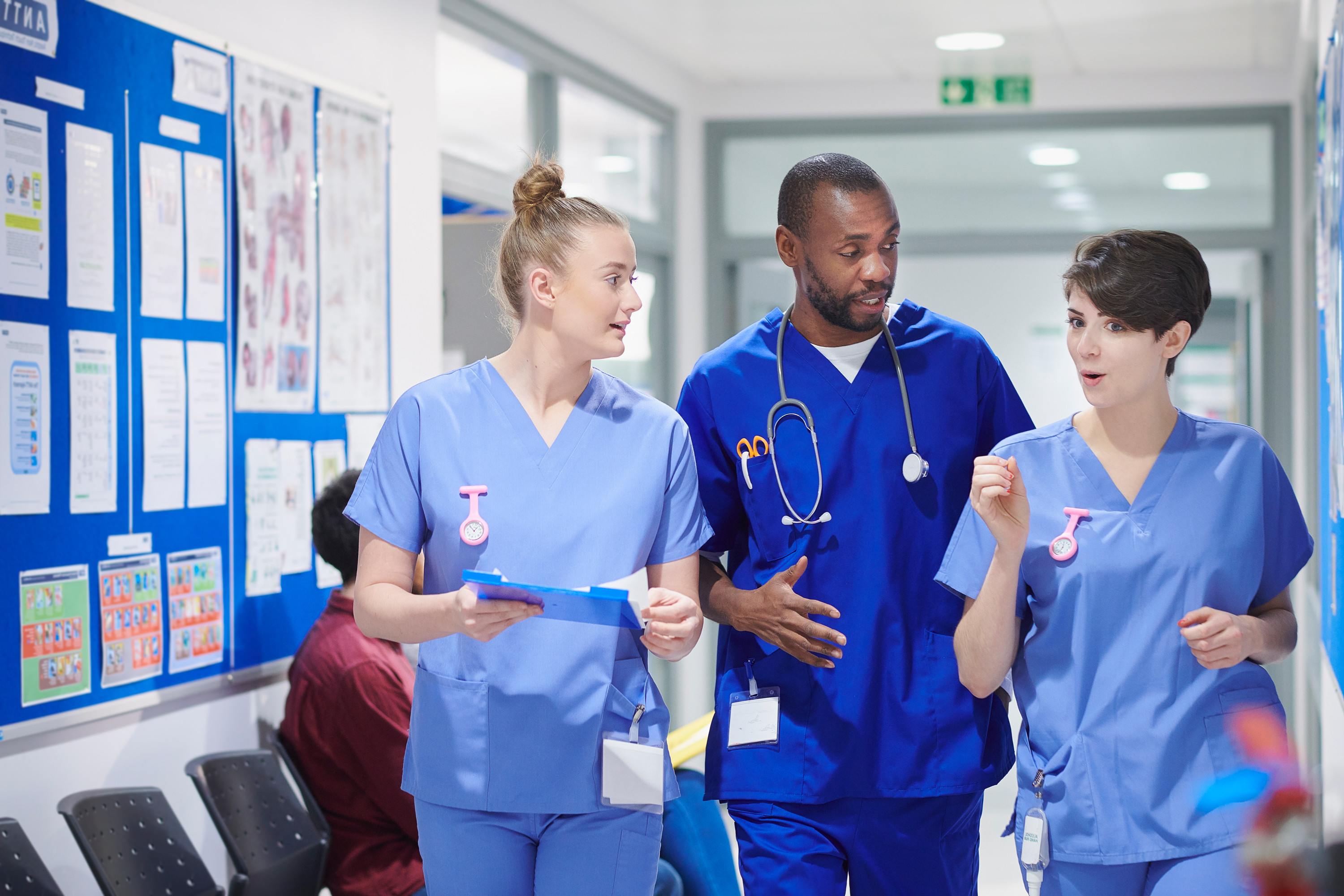 Hospital staff chatting in a hospital corridor