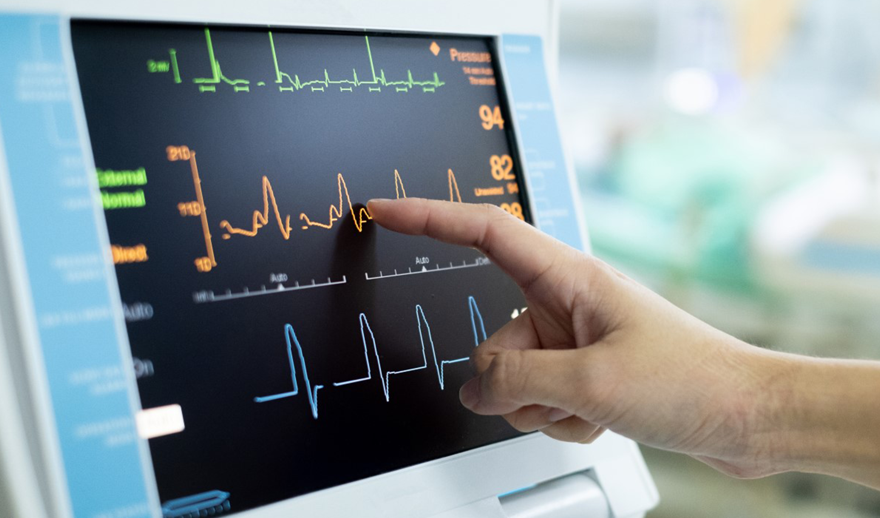 A hand points to heart monitor screen